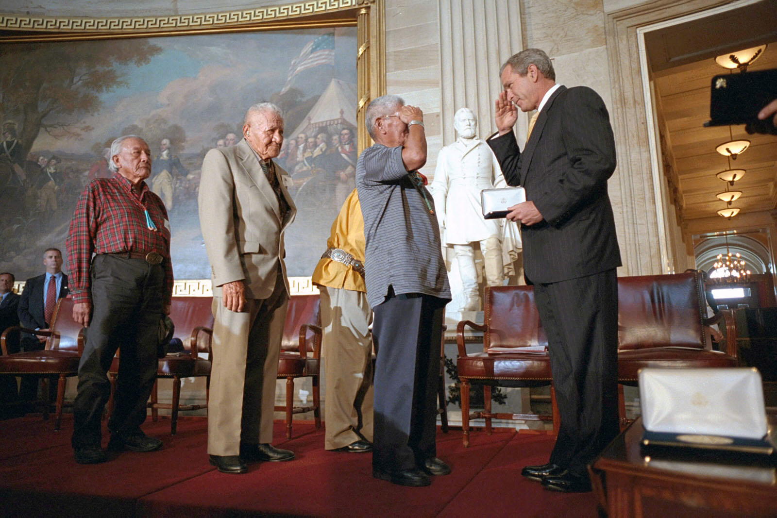 The last original code talkers John Brown, Chester Nez, Lloyd Oliver, and Allen Dale June receive their medals from President Bush in 2001. (Photo source: https://americanindian.si.edu/nk360/code-talkers/recognition/)